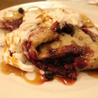 Wholemeal pancake with vegan whipped cream, maple syrup and forest fruits. Yummy! at Vegalite in Brno
