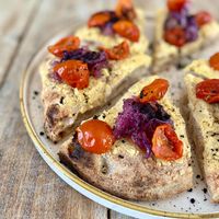 Botanica - impasto con aroma di mais e semi di girasole, hummus, cipolla rossa caramellata, pomodori semi-dry e polvere di olive  at Il Melograno in Trieste