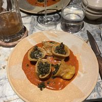 tortelloni with Preserved lemon plant-based ricotta, tomato sauce, wild pesto, crispy capers & tarragon oil  at MESA Restaurant in Paris