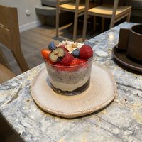 Overnight oats - hibiscus infused w/ vanilla yogurt, jam and seasonal fruits  at MESA Restaurant in Paris