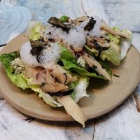 An amuse bouche of cold mushrooms on lettuce at MESA Restaurant in Paris