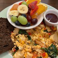 Tofu scramble (I had already eaten some when the photo was taken), hold the mushrooms, with side of fruit and rye toast at Junior's Cafe in Portland