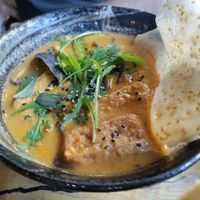 Coconut noodle soup with tofu and mushrooms at TA Vegan House in Hamburg