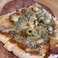 Pizza with vegan cheese at Triumph Cafe in Ushuaia