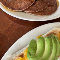 (A cramped photo of) Blueberry stuffed pancakes and breakfast burrito at Lotus Cafe and Juice Bar in Encinitas