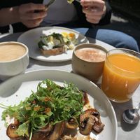 Hummus toast with mushrooms (vegan) and eggs Benedict on bread (vegetarian) for the hubby.  at Velvet Collective in Dusseldorf
