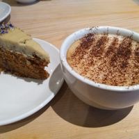 Carrot cake and oat milk cappuccino at The Quirk Space in Olney