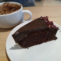 Chocolate cake with almond milk cappuccino at The Quirk Space in Olney