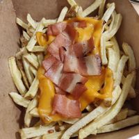 Fries with vegan cheese and bacon at Fantastic V in Madrid