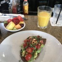Avocado tomato bread (without feta), orange juice and fruit salad at The Front Porch Cafe in Miami Beach
