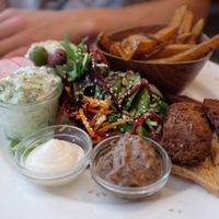 plate with dips, salad, falafel and fries at Cafe N in Copenhagen