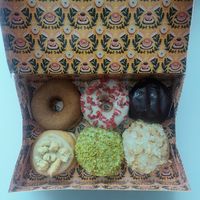 Bram's 6 Favourites: [clockwise] cinnamon sugar, white chocolate strawberry, Boston cream, bienenstich, pistachio, apple crumble at Brammibal's Donuts - KaDeWe in Berlin