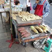 Grilled sweet potato, corn, banana, outside Silom Square. Vegan unless they are adding some sauce or flavoring at Chalawan - Vegan Food Stall in Bangkok