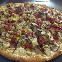artichokes, sun dried tomatoes, mushrooms, pine nuts and Canadian ham with vegan garlic white sauce at Pizza Guru in Santa Barbara