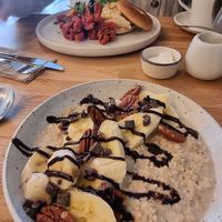 Porridge with oat milk and hummus and sunblush tomato bagel at Mr Cooper's Coffee House in Whitby