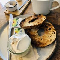 Bagel with vegan cream cheese and Whitby fog with oat milk.   at Mr Cooper's Coffee House in Whitby