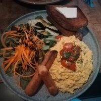 Scrambled tofu and two sausages with salad and bread at Palo Verde in Prague