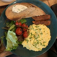scrambled tofu eggs, sausage, bread and salat  at Palo Verde in Prague