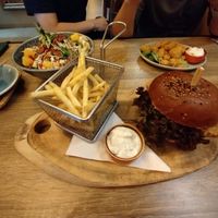 Korean no chicken burger, no chicken pops and seasonal palove bowl in the background  at Palo Verde in Prague