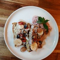 Waffles with cashew cream, maple syrup, fresh fruit and pink whipped cream at Palo Verde in Prague