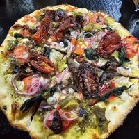 Pesto Pizza with sundried tomatoes, onion, eggplant, spinach and vegan cheese. Small size. at Minuteman Pizza in Uyuni