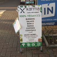 Karma sidewalk sign with some menu items  at Karma in Jaco
