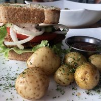 Chicken sandwich with roasted potatoes  at Karma in Jaco