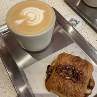oat latte and pain au chocolat  at Buddy Buddy in Brussels