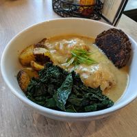 Biscuits and Gravy Bowl with potatoes, sausage patty, kale. at Back To Eden Bakery in Portland