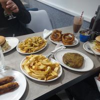 Battered sausages, pea fritter, chips, burgers and onion rings. at Captain Cod in Boston