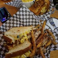 In the foreground, the Vegan Mac Daddy Patty Melt: A Beyond burger on grilled sourdough with caramelized onions, melted mozzarella, BBQ sauce and vegan macaroni and cheese. Served  at The Point in Bend