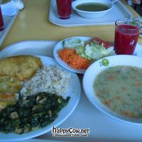 Lunch plate @ Zukini with fried fake ham empanada, two kinds of 'curry', rice, salad, quinoa soup, and juice. at Vegetariano Zukini in Bogota