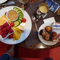On the right above a jar of soy milk and on the right a pack Alpro chocolatemilk and tiny vegan cupcakes. at SORAT Hotel in Berlin