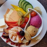 Vegan chees slices, houmous with herbs and beetroot houmous, vegan butter, peaches, mandarin, red currents, blackberries, red/yellow peppers, cherry toms, african ground cherries  at SORAT Hotel in Berlin