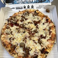 Bizarro vegan pizza (Vegan cheese, vegan sausage and meatballs, chili-garlic sauce, sun-dried tomatoes, caramelized onions)  at Bozzelli's in Washington