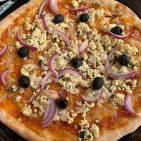 Sourdough pizza with “ricotta” style tofu. Very creative use of tofu and very delicious. More of a hard crust pizza, but delicious    at Odete Bakery in Porto