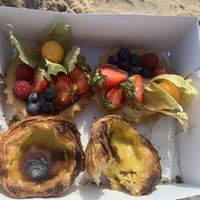 Take away nata and fruit tart for a trat at the beach    at Odete Bakery in Porto