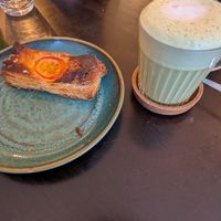 Pizza pastry is unassuming with my matcha latte but really good at Odete Bakery in Porto