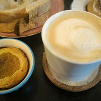 Café con leche de avena y pastelito de nata at Odete Bakery in Porto