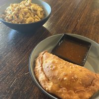 Lentil empanada with Mac & cheese  at Desmond's Island Soul Grill in Virginia Beach