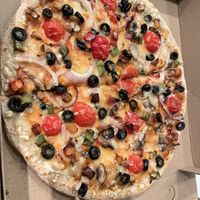 Vegan Greenhouse Pizza
Onion, Cherry Tomato, Mixed Bell Pepper, Black Olive, Mushroom, Vegan cheese   at NKD Pizza in Abu Dhabi