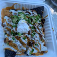 vegan nachos with cashew cheeze, ranch dressing, bbq sauce etc. at Flourish Plant-Based Eatery in Evansville