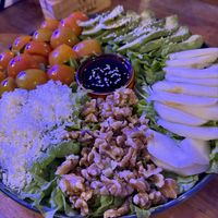Salad with lettuce, tomatoes, pear, avocado, walnuts, and vegan cheesee  at Pizzeria Napoli in Puerto Natales