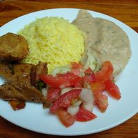 Rice, polenta, marinated seitan, delicious deep-fried carrot ball and salad. at Govinda Gopal - Govindas  in Quito