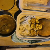 Vegan Colombo stew with sweet potato, fried plantains, rice, and Johnny cake (to-go)   at Lagoonies Bistro & Bar in Cole Bay