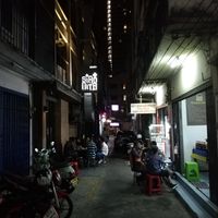 Head down the alley past these restaurants at Sugam Vegetarian in Bangkok