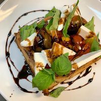 Tomato basket: A puff pastry filled with a honey mascarpone, heirloom tomato, basil, and ricotta salada, all topped with a balsamic glaze, aleppo, and sea salt at The Paddle Inn in Newburyport