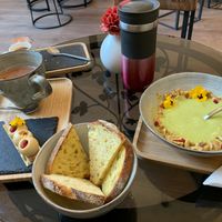 zucchini soup with bread (half portion already eaten), almond pastry (already eaten half), cup with hot chocolate at Be Nuts in Brussels