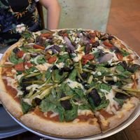 Veggie pizza with jalapeño dough (tomatoes, spinach, asparagus, olives, mushrooms) at La Masa Pizzería Conceptual in San Juan