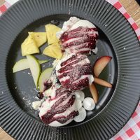 Vegan vanilla ice cream with coulis, but with non-vegan merengue all over it and next to it.  at Bodilles Kro in Skagen